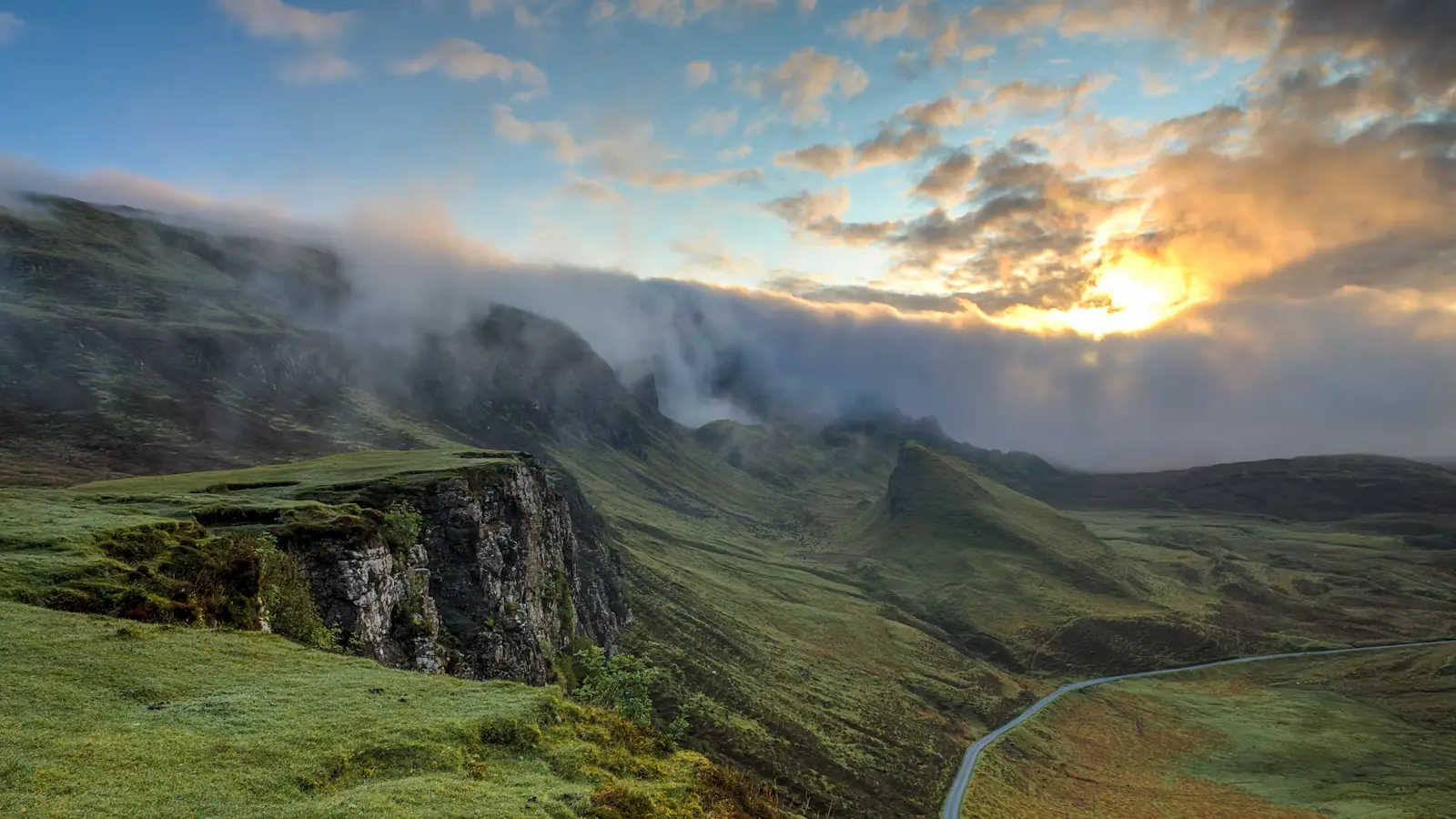 A bare ridgeline standing above a sea of cloud in early morning light