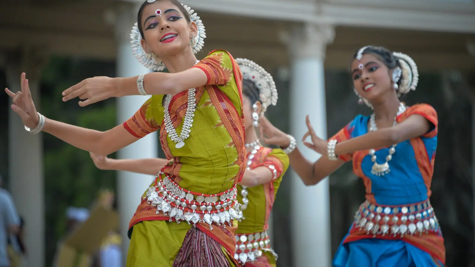Three dancers performing a traditional Polynesian dance